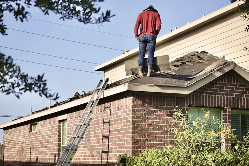 Professional roofer working on a residential roof in Roberts Mill Run